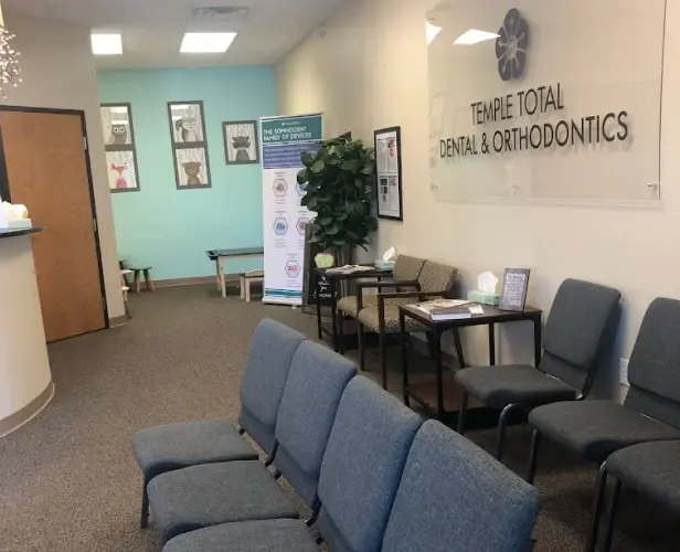 Temple Total Dental & Orthodontics waiting room with blue seating and reception area in Copperas Cove.
