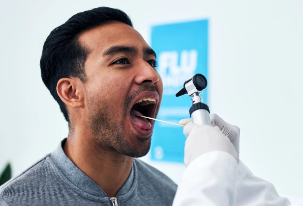 Man singing passionately into microphone at dental practice event or promotion